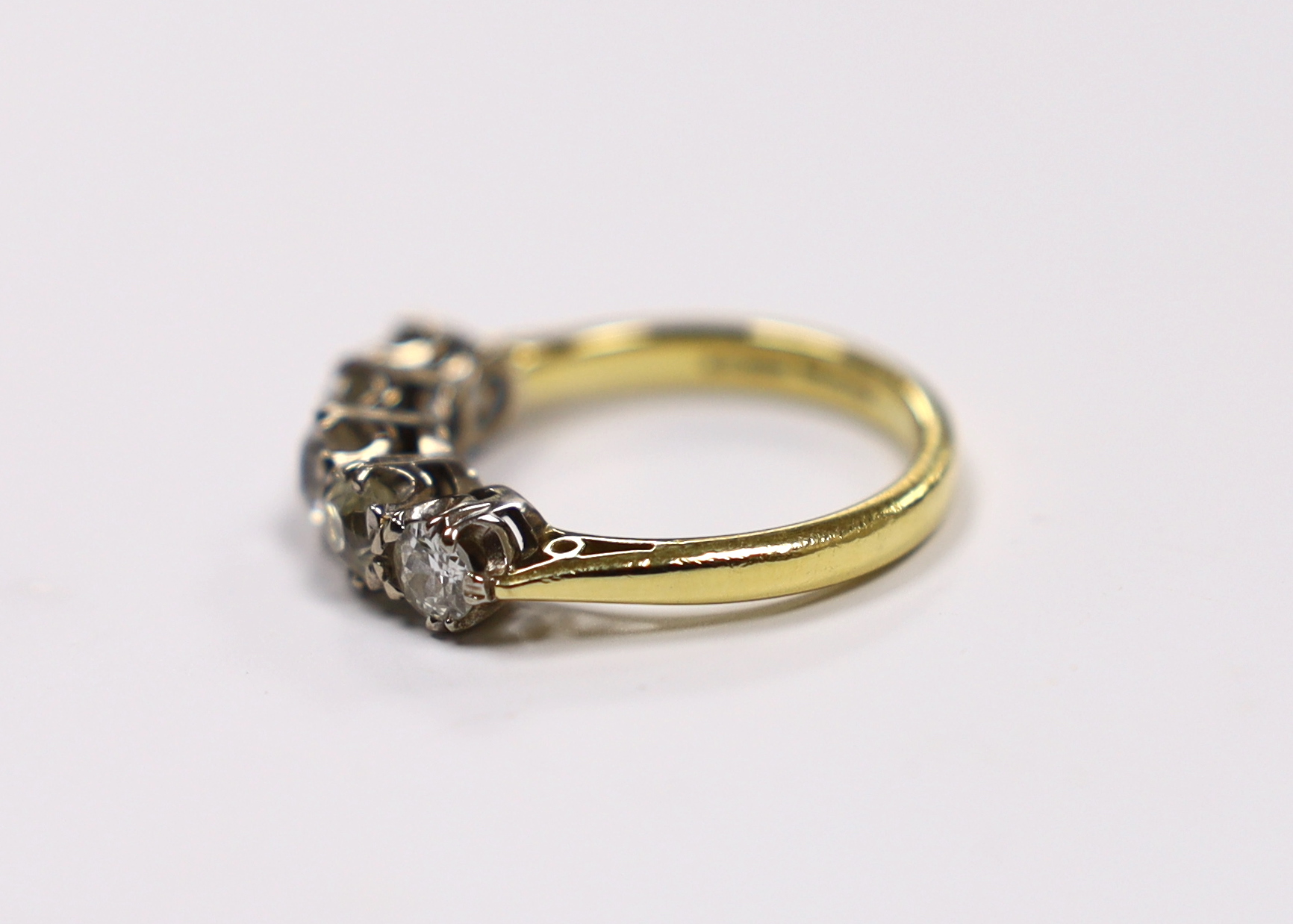 A modern 18ct gold and graduated five stone diamond set half hoop ring, size M, gross weight 4.5 grams.